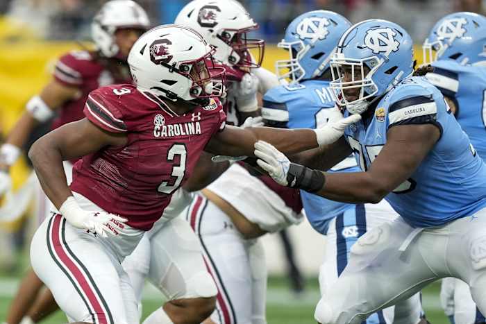 Dec 30, 2021; Charlotte, NC, USA; South Carolina Gamecocks defensive end Jordan Burch (3) tries to evade North Carolina Tar Heels offensive lineman Joshua Ezeudu (75) during the second quarter at Bank of America Stadium.